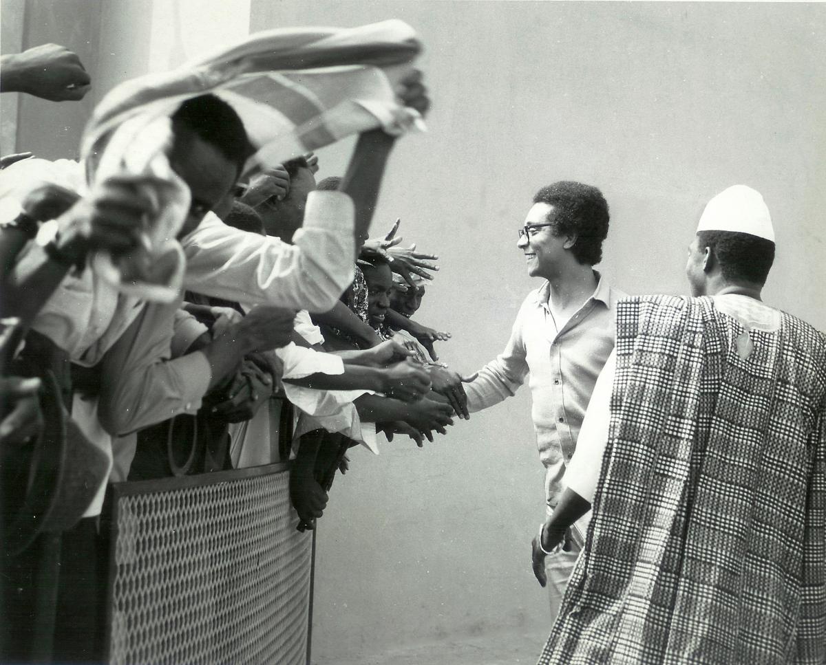 Collinet reaches out his hand to a crowd of eager fans, held back by a small wire barricade