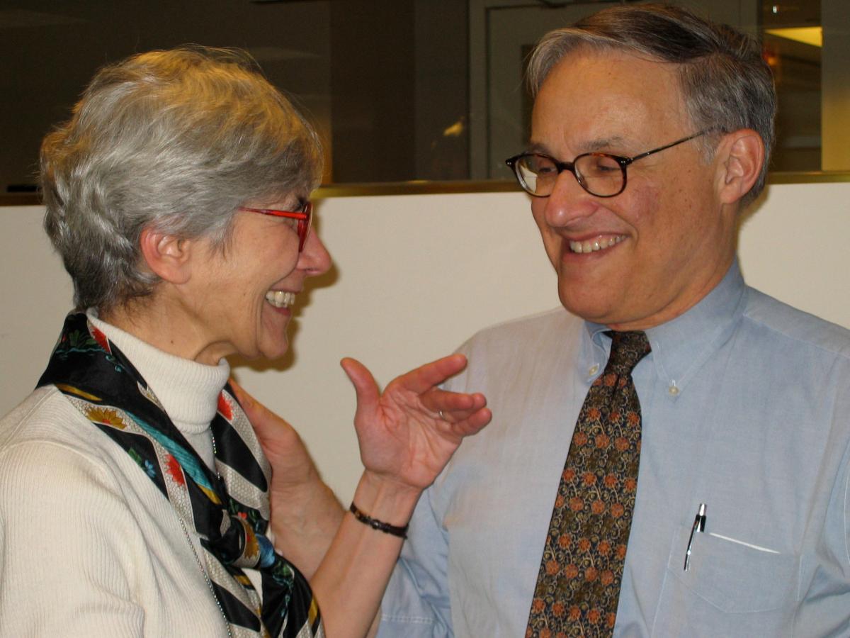 Color photo of Amy and Leon Kass laughing together.