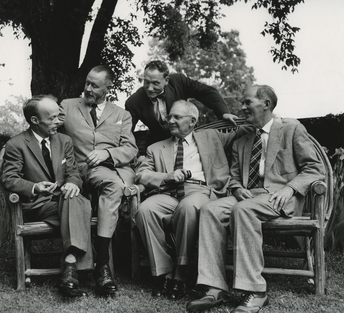 Black and white group photo of the authors, in conversation