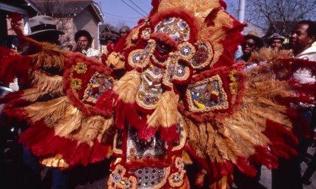 Photograph of an elaborate red and yellow sequined costume with wings