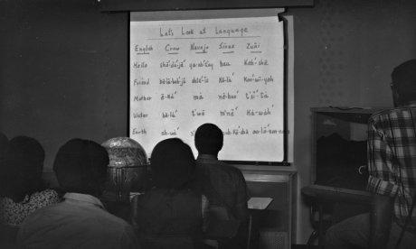 black and white photo students looking at projector screen