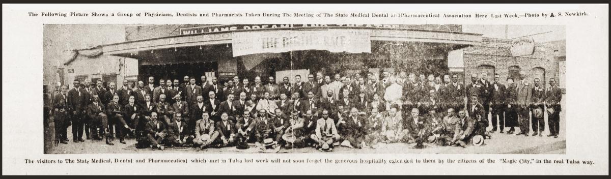 A panoramic photo of more than a hundred visiting Black medical professionals standing in front of Williams Dreamland Theatre