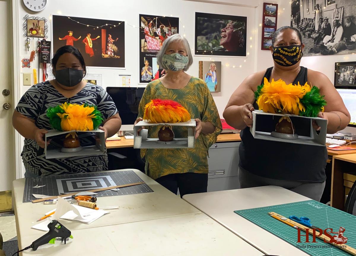 Conservator Linda Hee trains the team on housing for fragile feathered gourds called ʻulīʻulī.