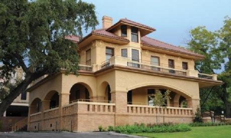 Color photo of a mansion of Spanish-style architecture.