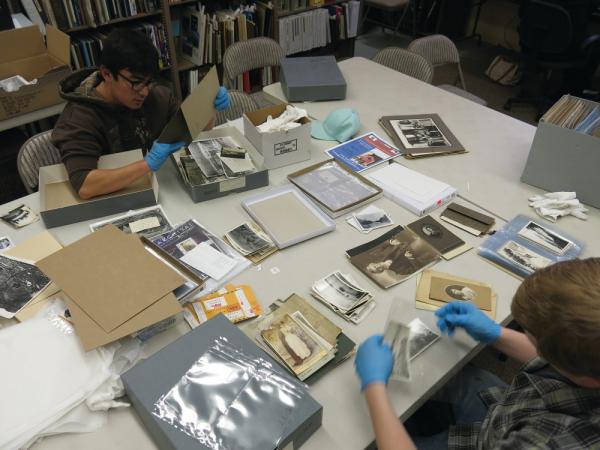 Volunteers sleeve historic photos