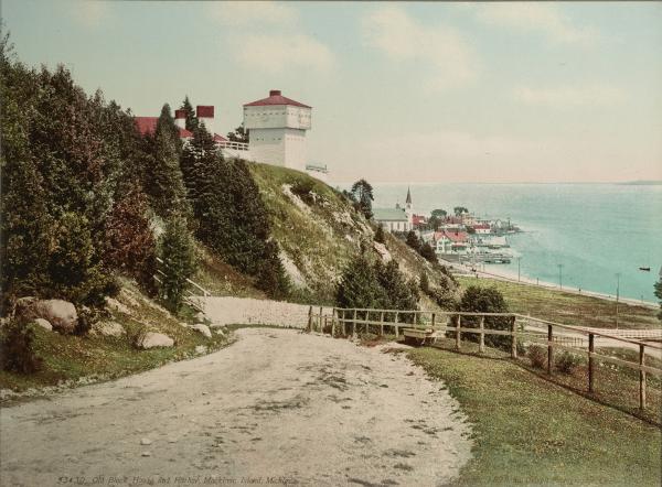 Image of a rock cliff and neighboring sea town