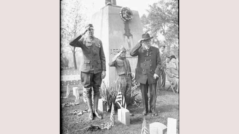 black and white photo of two men and a boy saluting