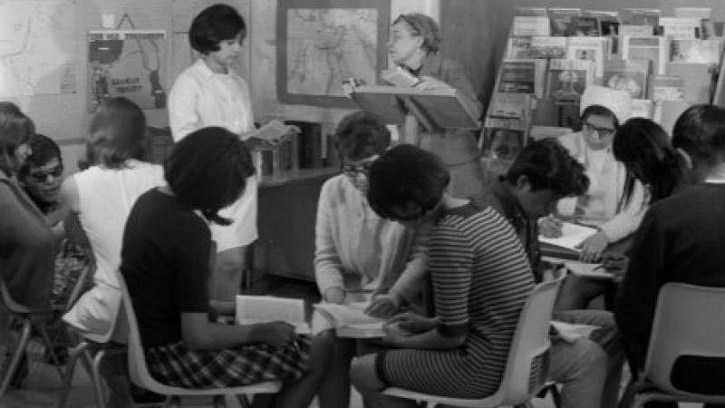 black and white photo of students working in studio