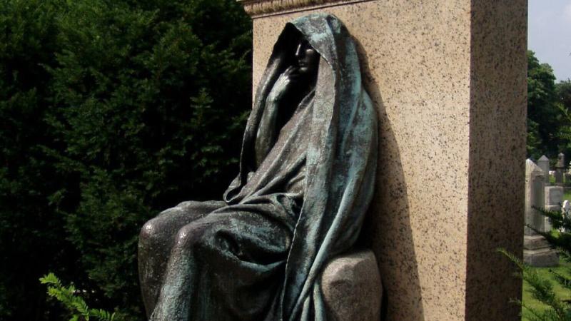 Stone sculpture of a woman in a flowing wimple.