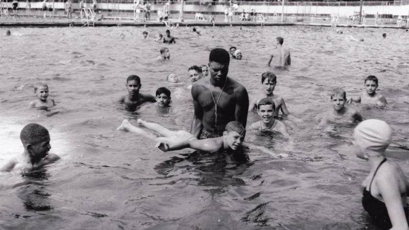 Lifeguard teaching boy to swim, Highland Park swimming pool, 1951.